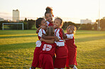 Celebration, hug and children soccer team happy for a goal on the outdoor football field. Happiness, excited and sport friends playing girls football game together and celebrating success and winning