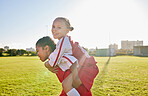 Girl soccer and team friends on field enjoying match game leisure break with fun piggyback ride. Happy, young and excited football children relax together on sport ground in athlete uniform.