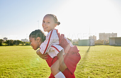 Buy stock photo Girl soccer and team friends on field enjoying match game leisure break with fun piggyback ride. Happy, young and excited football children relax together on sport ground in athlete uniform.