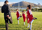 Soccer, team and stretching girl with coach on a sport field while training, exercise or practice together. Teamwork, collaboration and motivation with football group with fitness workout before game