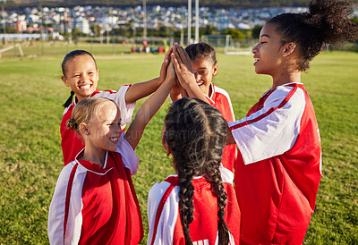 Buy stock photo Children, girl football team and high five for sports group motivation on a soccer field for celebration of goal, winning and teamwork outdoors. Junior competition for kids diversity tournament match
