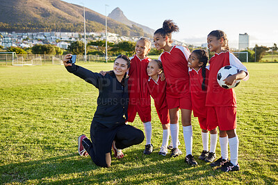 Buy stock photo Soccer, team and coach selfie with phone on a field after training, practice or game at a sports club. Football girl group smile and happy with photo for social media on a sport ground together