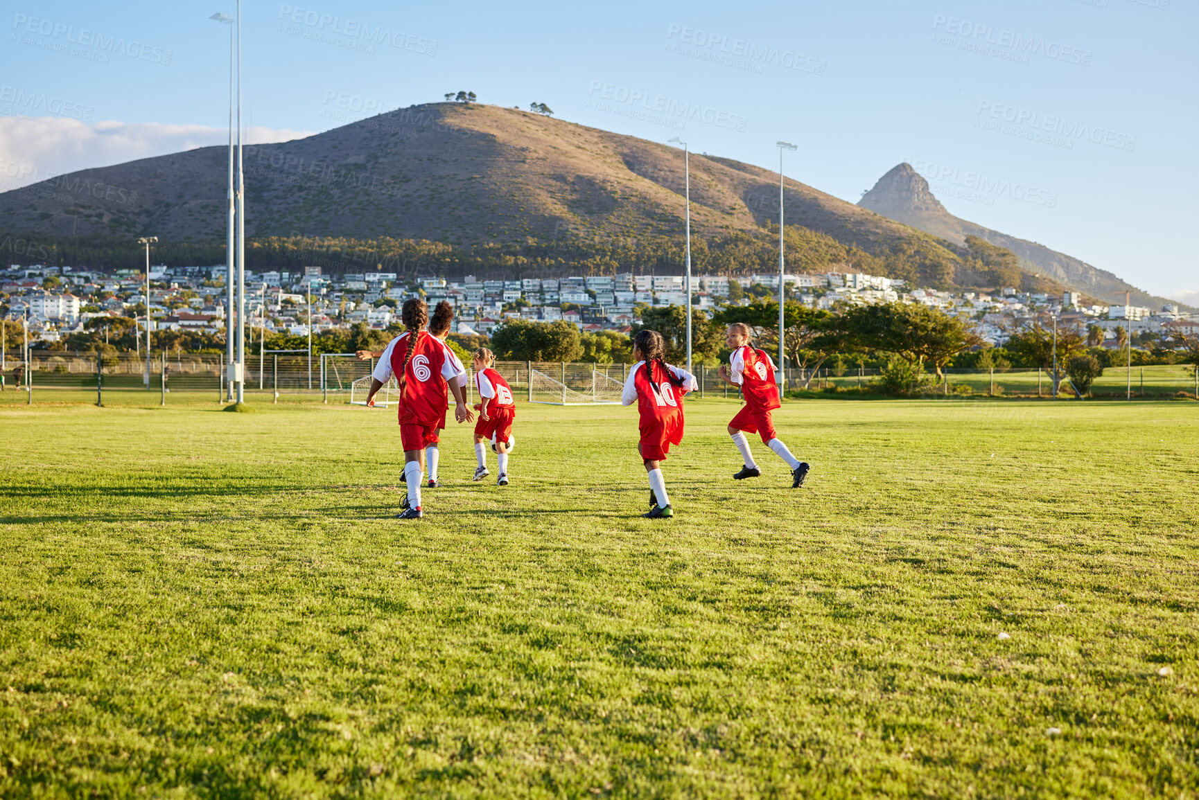 Buy stock photo Girls, soccer team or fitness game on grass field in workout, training or exercise for game or match goals. Running, football or sports children, students or kids in energy competition at high school