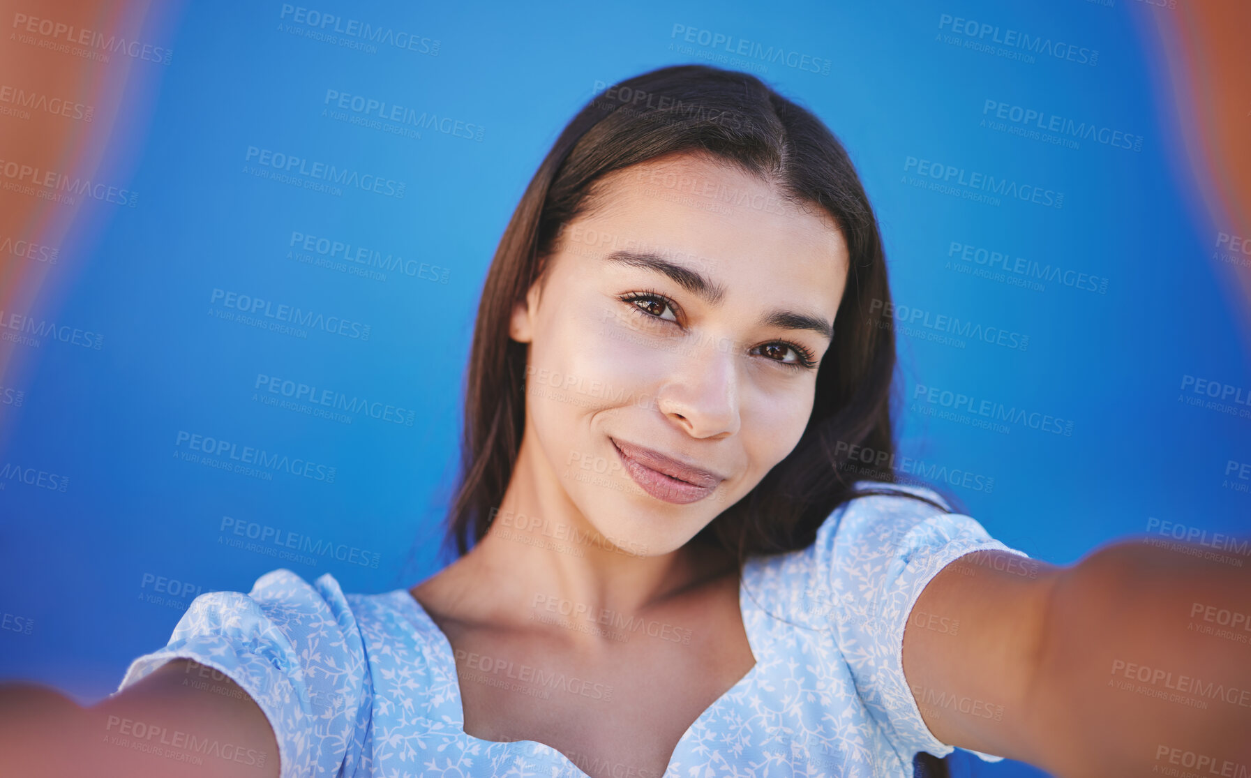 Buy stock photo Smile, happy and taking selfie with woman showing face during travel against blue background. Pov portrait of smiling female with natural beauty taking a photo and having fun for social media