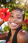 Summer flower, sunshine and black woman facial beauty care. Happiness, inner beauty and natural happy glow or smile on relaxing, wellness and self-care vacation near Hibiscus plant tree