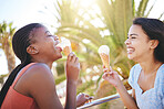 Happy, smile and friends with ice cream on the beach while on summer vacation or trip together. Happiness, laugh and girl best friends eating dessert in nature by the ocean or sea while on holiday.