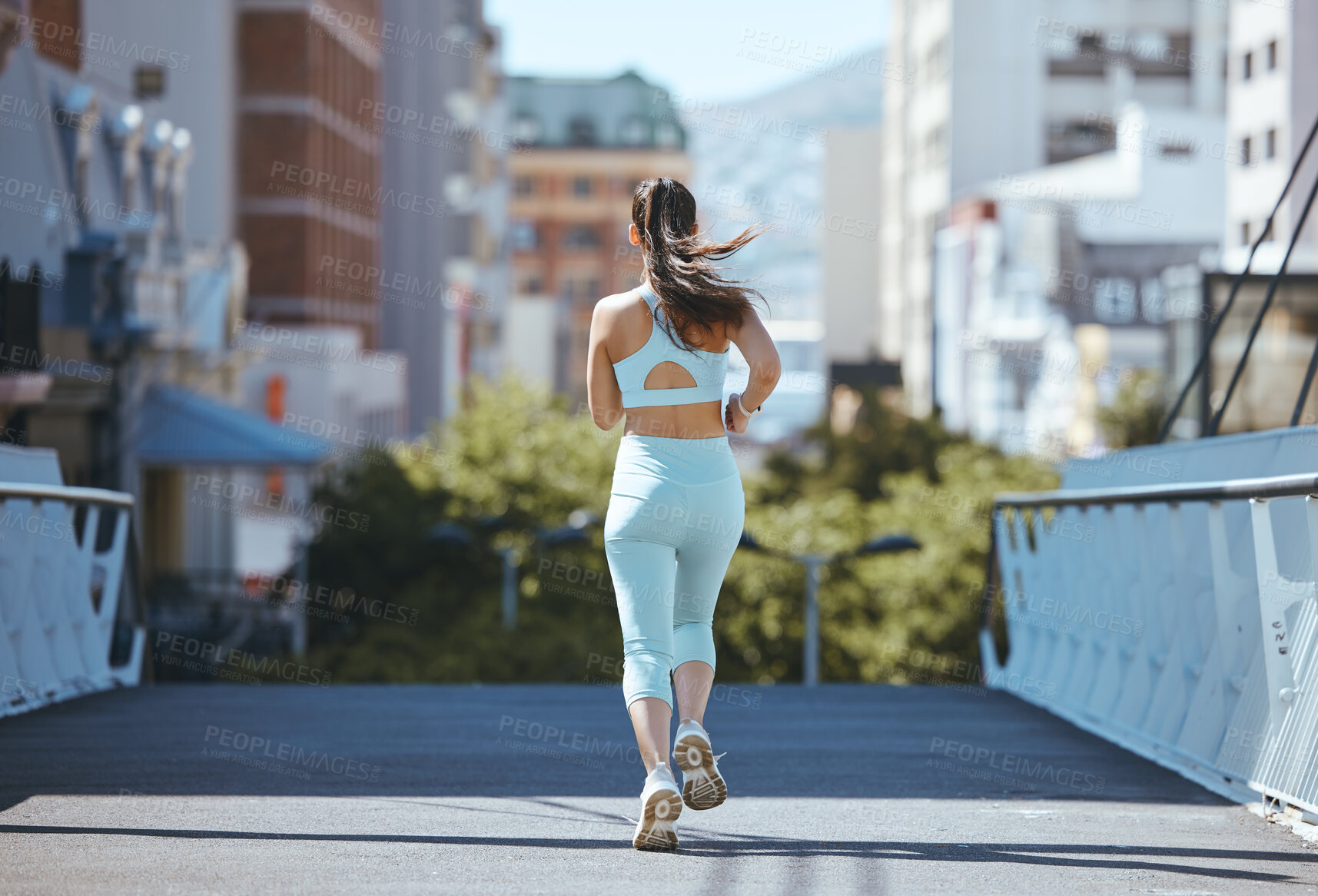 Buy stock photo Fitness, runner and back view of woman running, exercise and cardio training outdoors on bridge asphalt in summer. Wellness, sports and young girl on a healthy and active city jog workout on the road