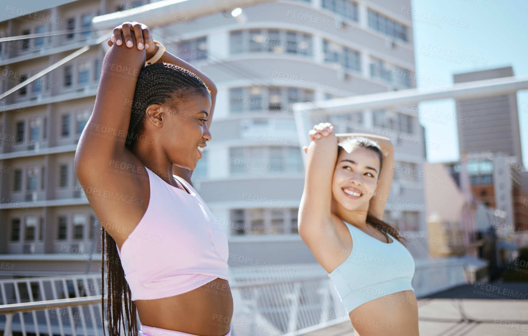 Buy stock photo Interracial woman, fitness friends and stretch for exercise, workout and training in the city outdoors. Happy, young and active women smile together in sports activity, stretching in a urban town