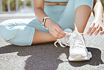 Shoes, feet and woman in the street for run in the city of Australia for cardio, fitness and workout. Athlete runner training for running marathon, exercise and body health on the urban road