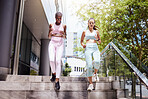 Fitness, exercise and women friends running on building steps, speed and cardio workout in a city. Wellness, energy and personal trainer showing support and motivation for endurance goal performance