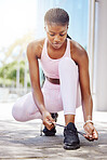 Black woman, runner and exercise tie shoelace for running outside in summer for wellness, health and fitness. Girl, shoes and sunshine on terrace ready for workout with training clothes to be healthy