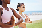 Women, yoga and prayer pose in park, nature or outdoors meditation, fitness or stretching. Zen, relax and females practicing pilates for health, mindfulness and wellness together on grass outside.
