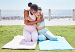 Yoga, love and fitness with girl friends hugging during a workout, exercise or training by the beach. Sports, health and wellness with a black woman and friend exercising by the sea or ocean