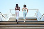 Fitness friends, running steps and women exercise together for healthy lifestyle, wellness and marathon workout in urban outdoors. Back of athletes, runner city training and cardio workout on stairs