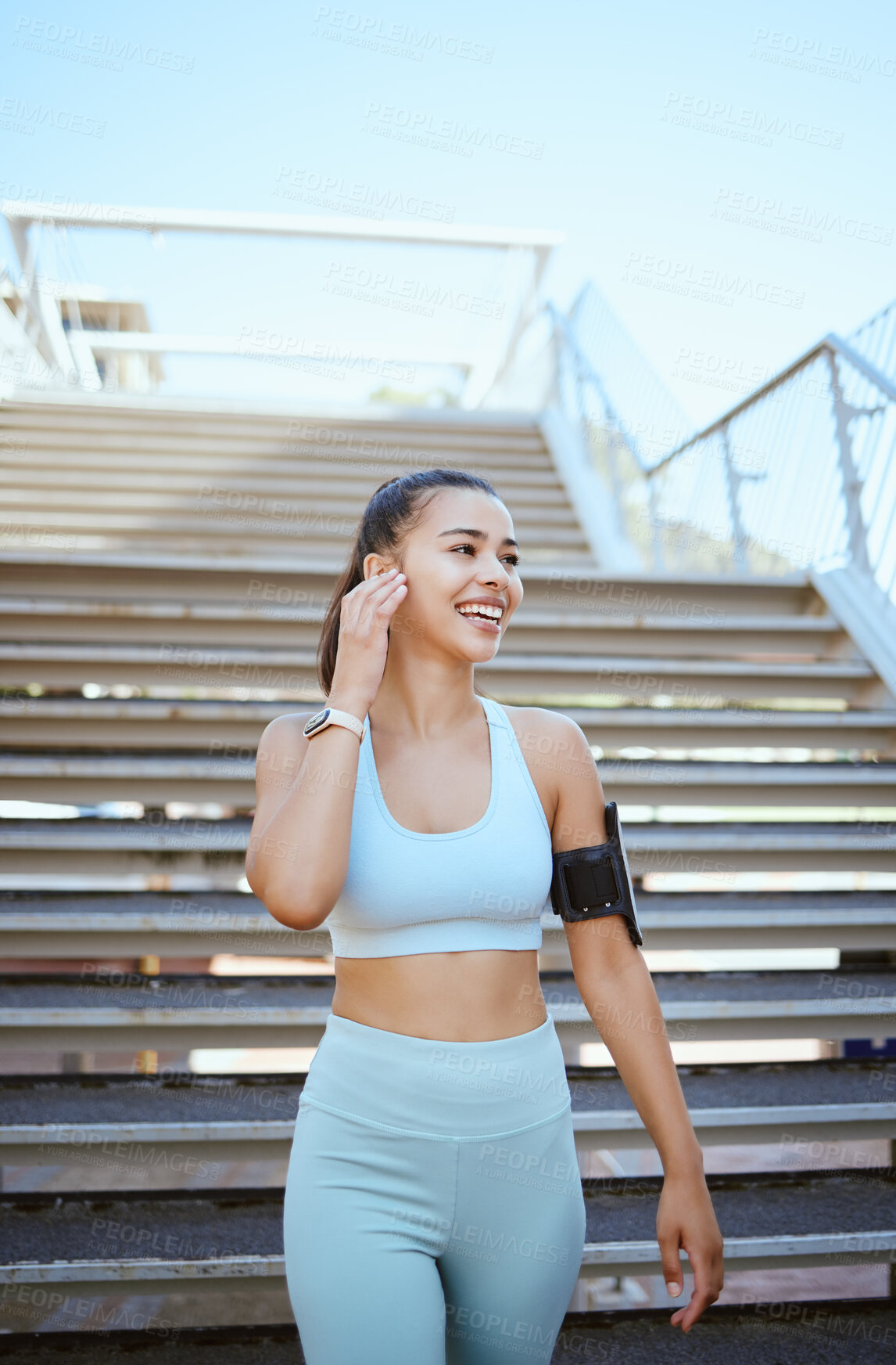 Buy stock photo Fitness, exercise and music with a woman runner or athlete streaming radio outside for workout, training and health. Sports, healthy and cardio with a female listening on earphones while out on a run