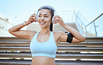 Fitness, healthy, woman listening to music on a wireless headset while training outdoors. Young female running or sports workout with motivation, wellness and training podcast on Spotify.