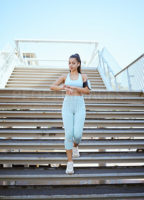 Buy stock photo Fitness, smartwatch and health tracking with sports woman checking pulse and progress during exercise on building steps in a city. Training, time and cardio workout by Mexican girl monitor wellness