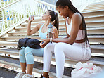 Water, fitness and friends training on stairs in the city of Sweden for workout in summer. African athlete and black woman runner drinking from bottle for energy after exercise together