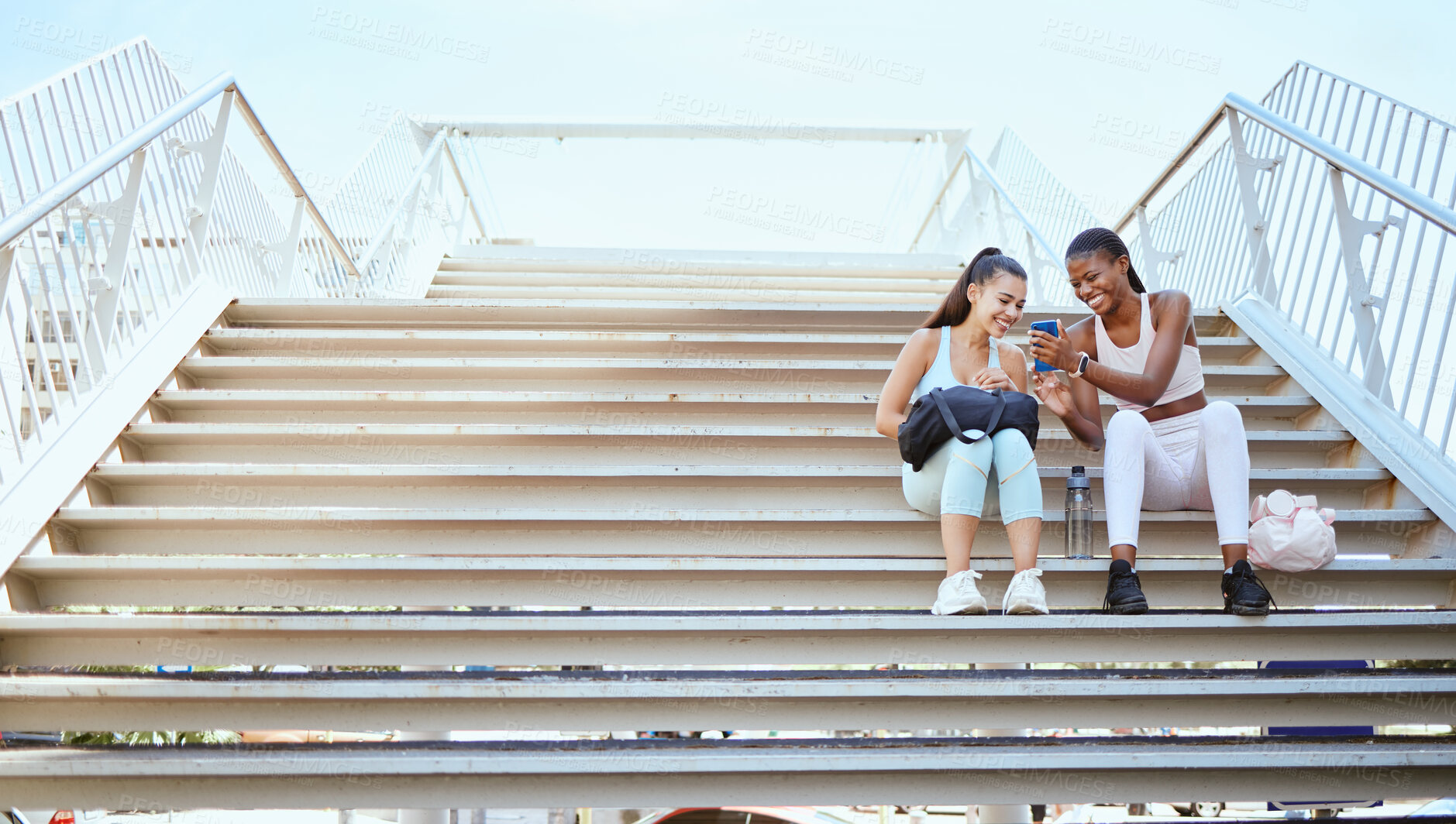 Buy stock photo Workout, comic and woman with phone on stairs after doing fitness training in the city of New York together. Runner and black woman talking about funny 5g mobile app after health exercise on steps