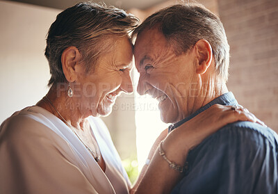 Buy stock photo Love, happy and laugh elderly couple hug and bond in their home together, cheerful and sharing a funny joke. Humour, care and affection by senior man and woman enjoying retirement and playful fun 