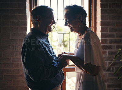 Buy stock photo Love, happy family and senior couple laugh and relax in dark room, bond and share funny joke in their home. Retirement, humour and affection by sweet elderly man and woman smile, enjoy time together
