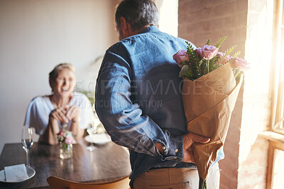 Buy stock photo Surprise, flowers and senior couple in celebration of an anniversary, marriage or birthday at a restaurant. Elderly man giving bouquet of roses to woman during dinner date for love at a coffee shop