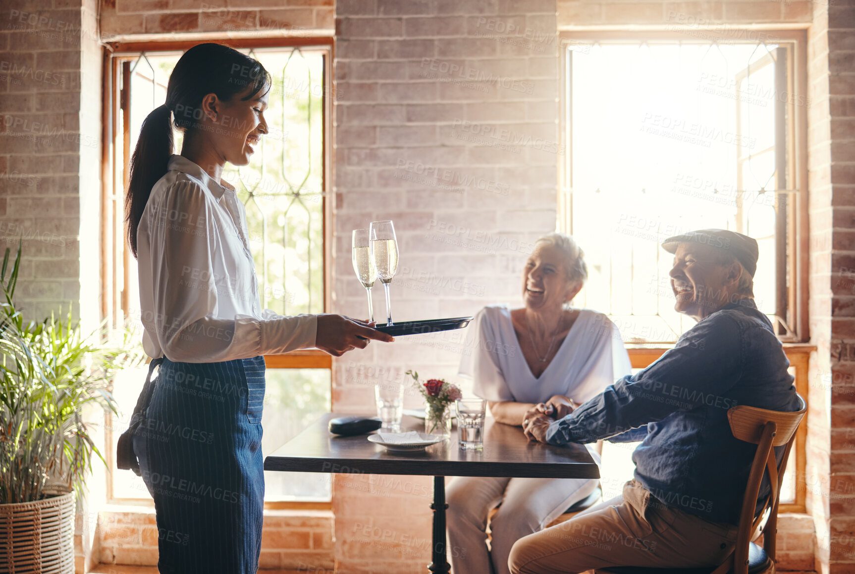 Buy stock photo Restaurant waitress, wine glass and service to happy couple for dinner celebration, lunch and fine dining. Cafe hospitality, alcohol champagne glasses and drinks menu order to elderly customers table