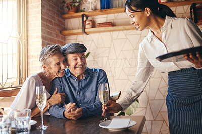 Buy stock photo Love, couple elderly and celebrate marriage with date and wine at restaurant, happy, smile or relax together. Loving, senior man and woman with champagne for celebration of retirement or anniversary
