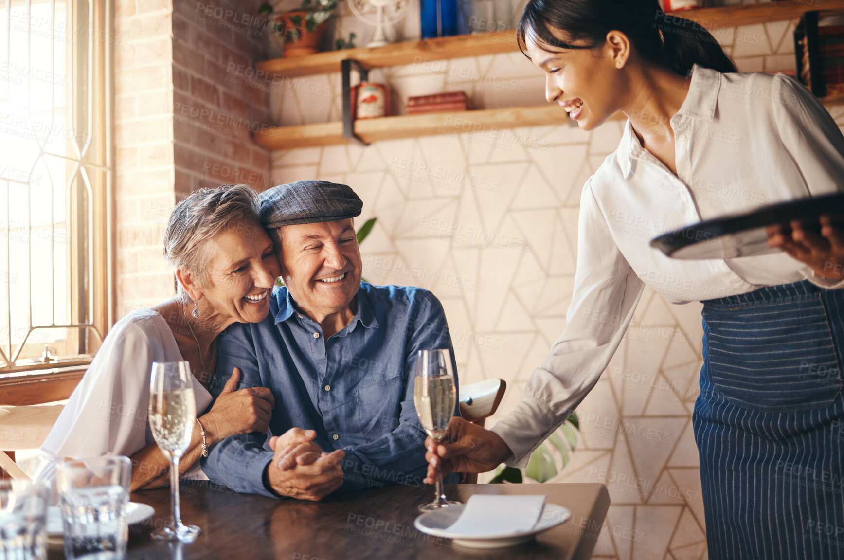 Buy stock photo Love, couple elderly and celebrate marriage with date and wine at restaurant, happy, smile or relax together. Loving, senior man and woman with champagne for celebration of retirement or anniversary
