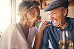 Senior, couple and laugh after comic joke together in home for bonding time. Smile, man and woman in retirement laughing at funny conversation with love, happiness and comedy in house with wine