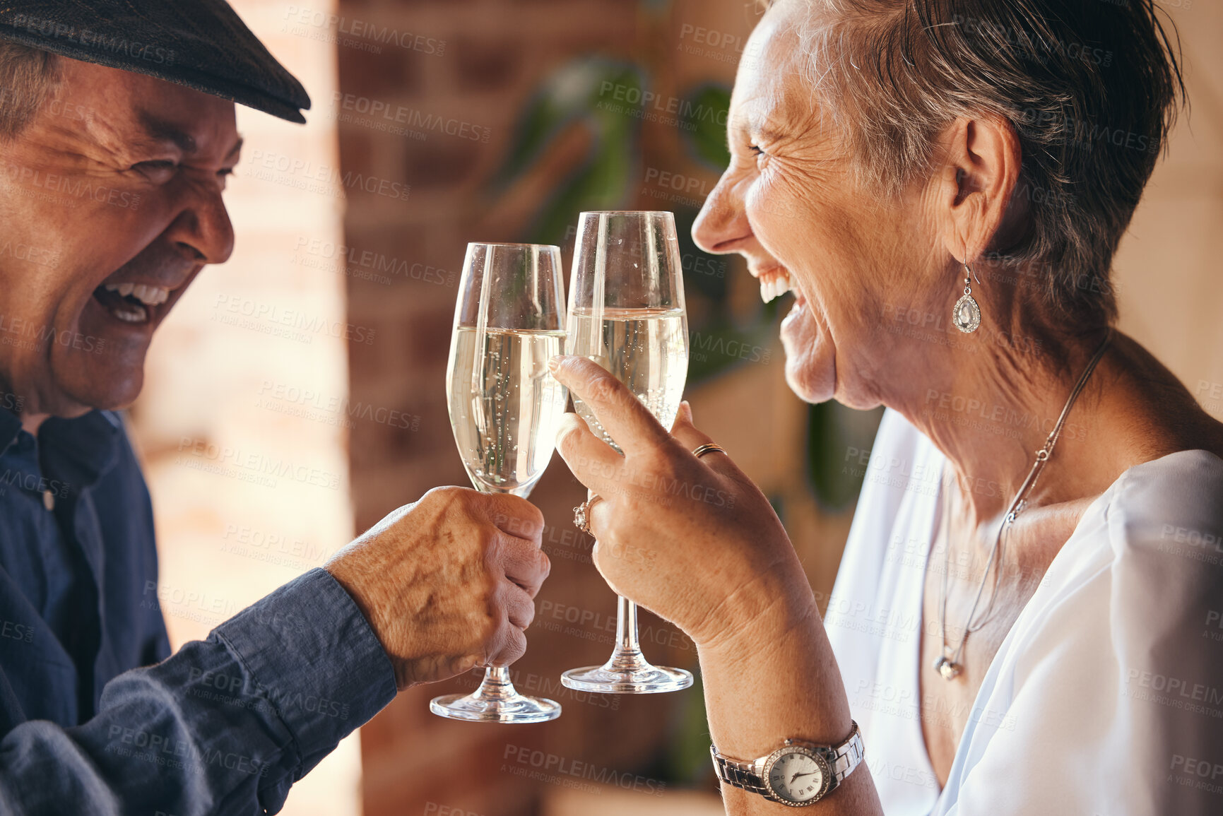 Buy stock photo Champagne, toast and elderly couple laugh and relax, bond in celebration of anniversary or retirement in their home together. Love, happy and success with senior man and woman cheers to relationship