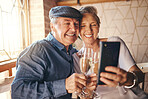 Senior couple taking selfie with phone, champagne and love for marriage anniversary, celebration or birthday at house. Happy, married and smile man and woman post on social media with alcohol in home