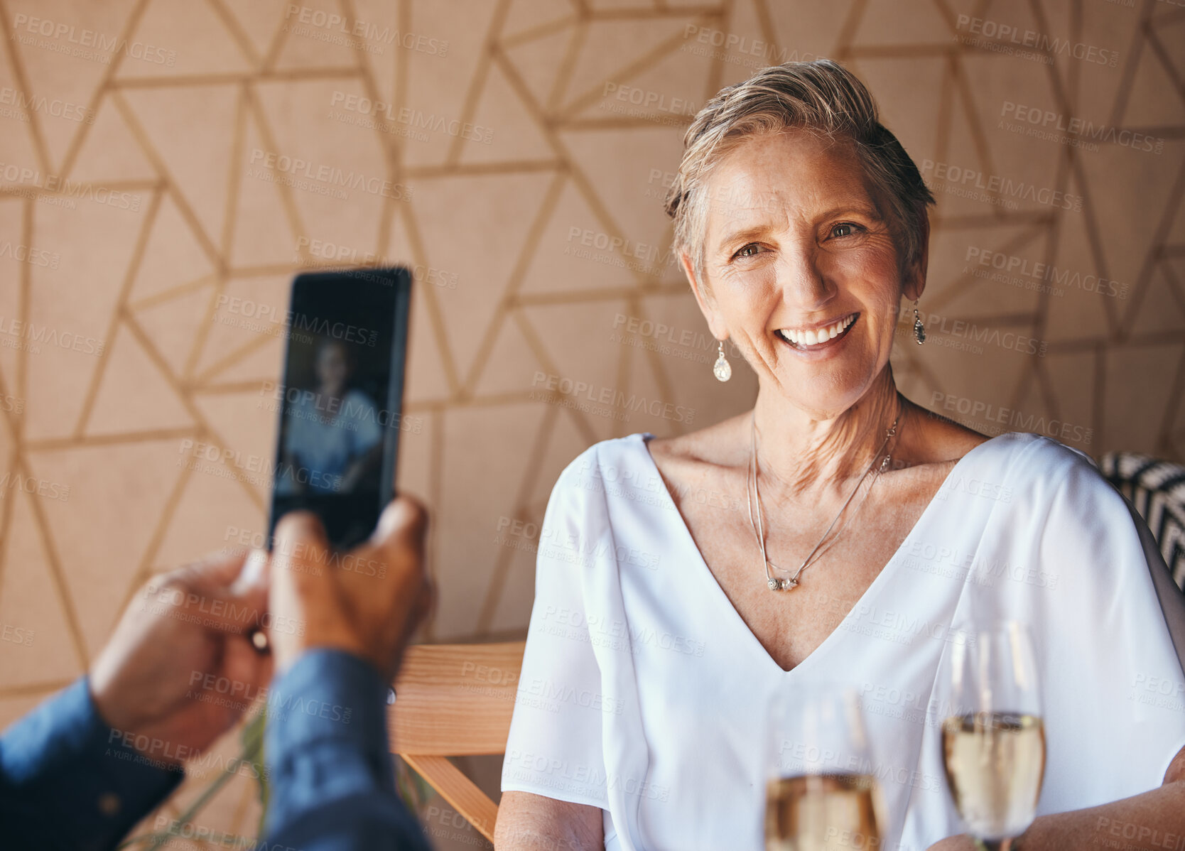 Buy stock photo Smile, phone and photograph, senior woman on lunch date in cafe with with champagne. Smartphone, picture on screen and a happy elderly couple in love on romantic anniversary celebration in restaurant