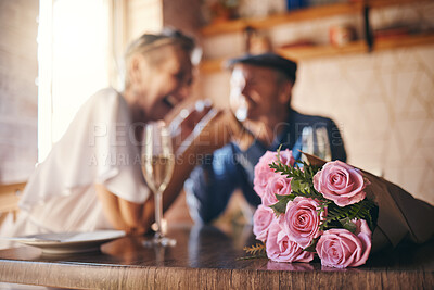 Buy stock photo Love, celebration and of roses for couple marriage anniversary with champagne for toast. Romantic, happy and caring senior people in relationship commitment together enjoy intimate date.