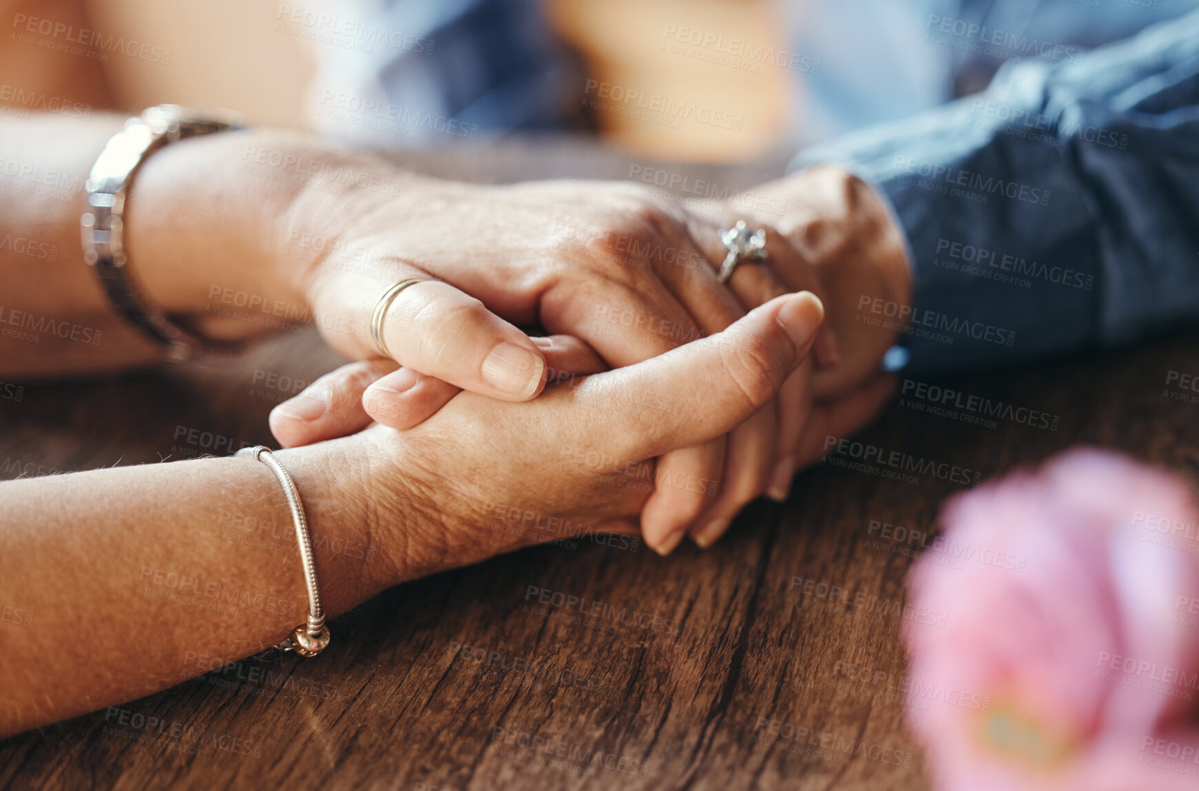 Buy stock photo Macro, couple and elderly people holding hands on table for support, love and care in home. Zoom, senior and hand together for bonding, anniversary and romance in marriage, life and retirement