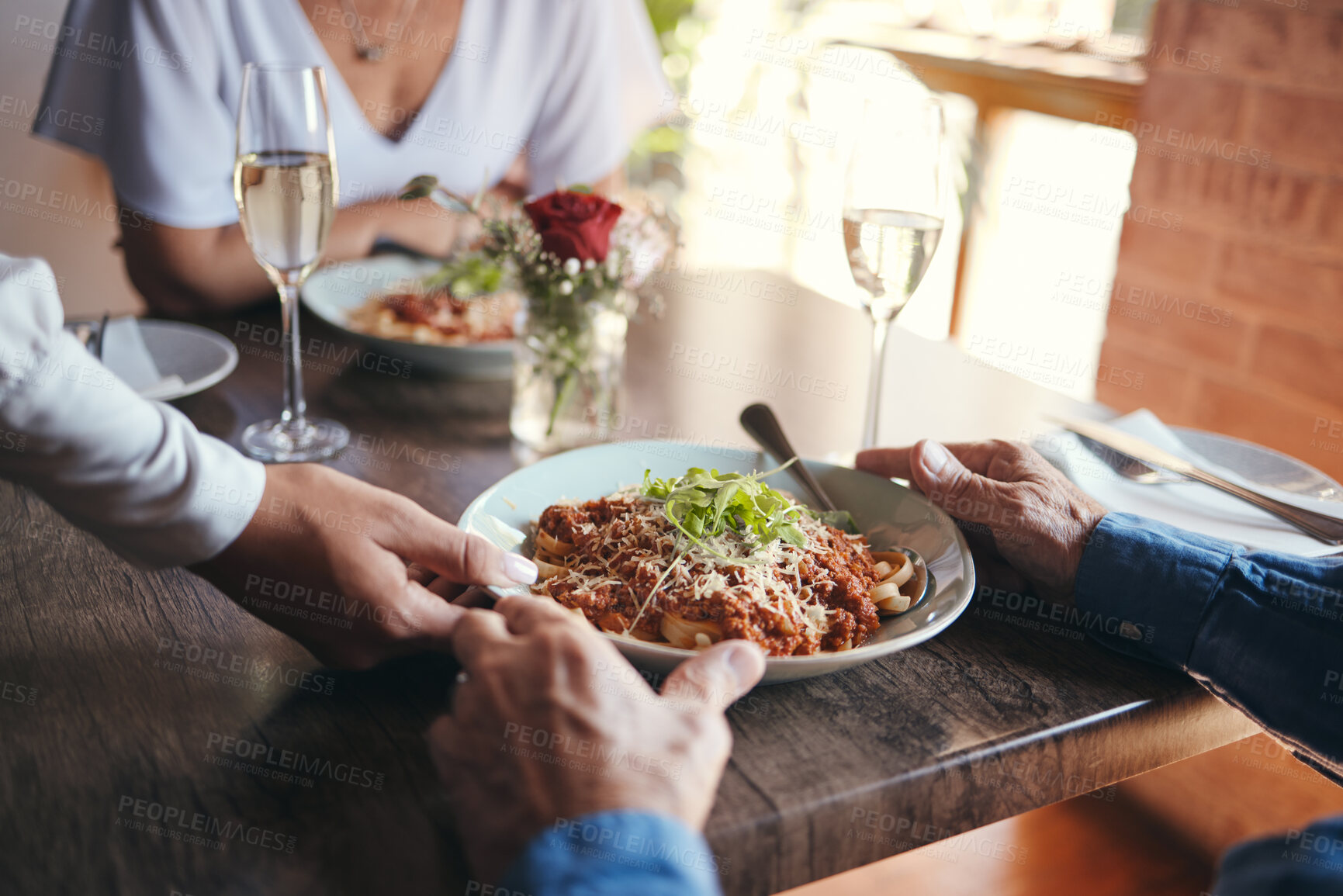 Buy stock photo Food service, wine and couple at table with hospitality from waiter at restaurant for lunch. Cafe worker with plate of pasta for man and woman on date for anniversary or marriage at fine dining cafe