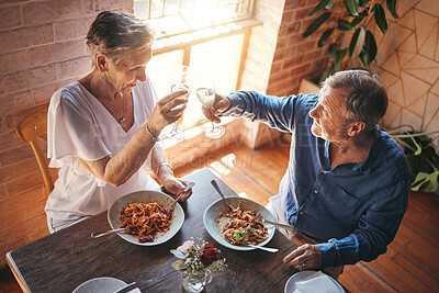 Buy stock photo Senior couple, food and champagne in a restaurant while sharing a toast for celebration of love for an anniversary. Elderly man and woman with alcohol drink celebrating marriage eating pasta in Italy