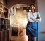 Woman at hospitality restaurant, a waitress with smile and confidence waiting for customers for dinner or lunch service. Portrait of friendly, professional watering staff in uniform and a clean apron