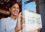 Hiring, recruitment and coffee shop with a woman small business owner hanging a sign in her window. Cafe, startup and management with a female entrepreneur ready to interview staff for a job opening