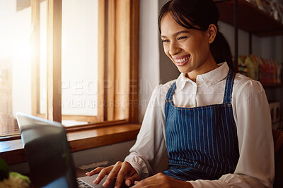 Buy stock photo Coffee shop owner on laptop, startup and woman from Singapore typing email or planning menu online. Happy manager at cafe or restaurant reading review on shop social media or positive sales report.