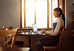 Computer working, coffee shop and woman restaurant worker on a work break. Happy smile of waiter employee online at a cafe using technology, web and internet reading a job email with happiness