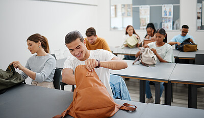 Buy stock photo University students in a classroom, learning education at college in a diversity rich environment. Young men and women are excited to study and learn as they search for stationary in backpack.
