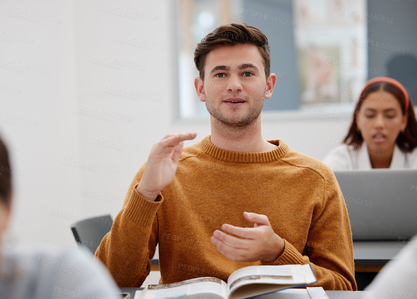 Buy stock photo University, lecture and classroom student for question, speaking or talking of research results, book summary or education course. Young man learning knowledge in college school studying information 