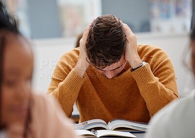 Buy stock photo University, study and tired student reading book in class while studying for test or exam. Education, stress and burnout man with headache, knowledge and scholarship learning college work in library.