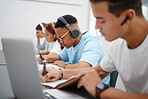 Students at university study, writing and research for a exam or project with headphones for podcast or music. College, school or education people learning, scholarship and studying on campus in hall