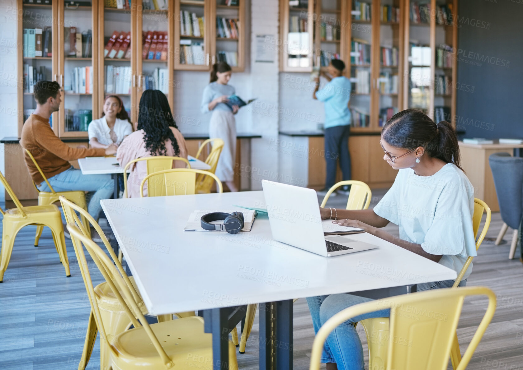 Buy stock photo Studying, library and student in university writing ideas in notebook, planning research strategy on laptop for course work. Community, education and knowledge with college people learning and books