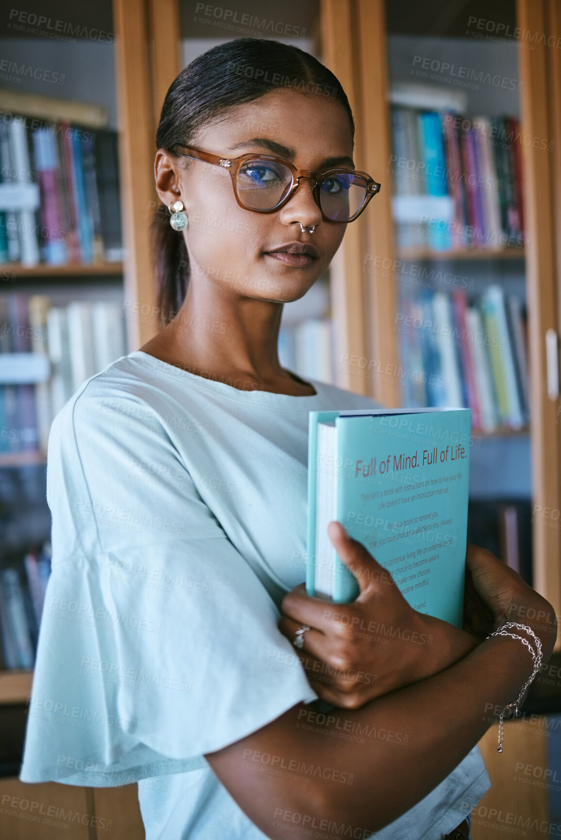 Buy stock photo Woman student with library print books from shelf for college or university education and learning knowledge. Young female or person with hardback English book in hands for studying or reading