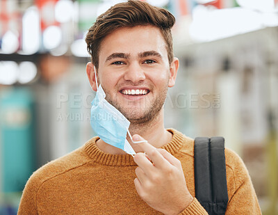 Buy stock photo Freedom, covid and man take off mask at college or university. Health, safety and compliance for covid 19 virus rules with student in Canada happy, cheerful or excited with end of corona pandemic.
