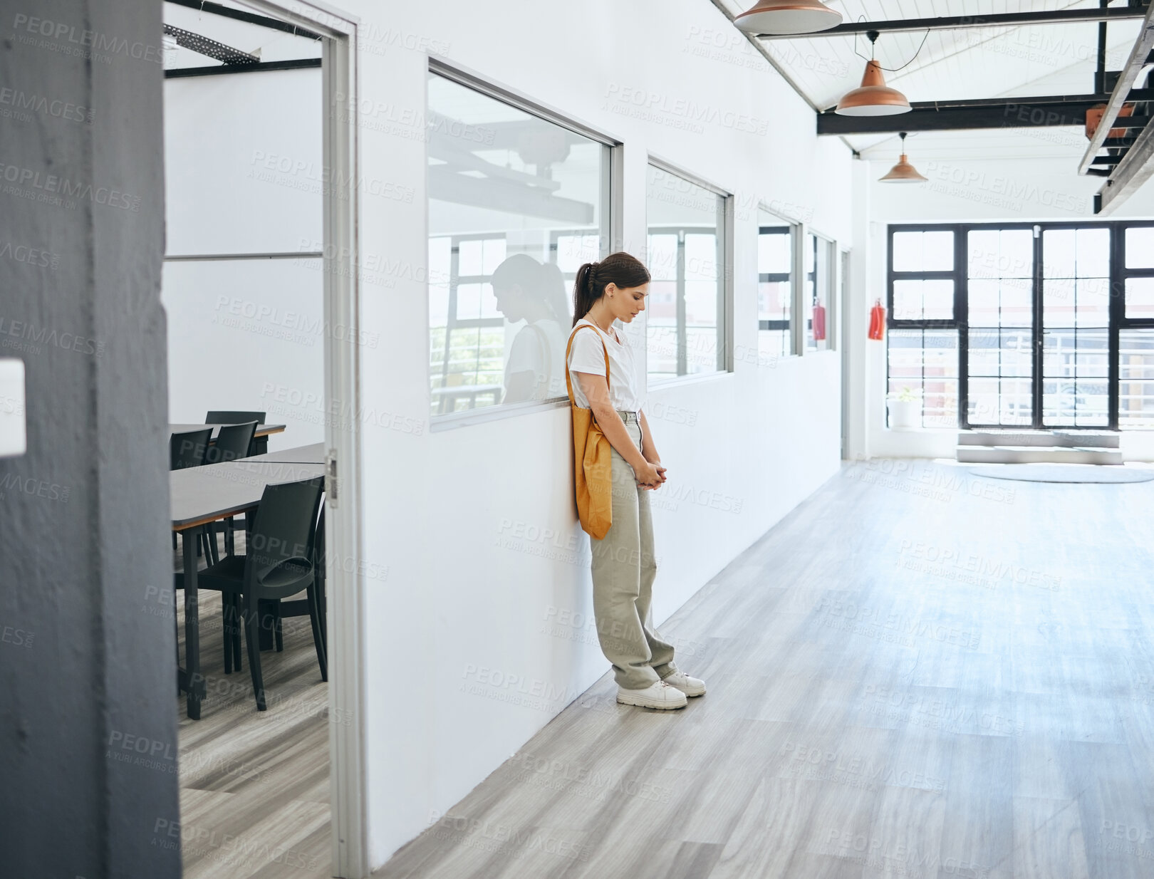 Buy stock photo Depression, stress and woman standing in office upset, sad and disappointed after job loss, fired or mental health problem. Female feeling burnout, anxiety and hopeless looking or waiting for job