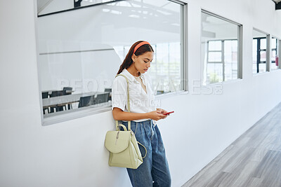 Buy stock photo Girl, student and phone in college by classroom window in university for email, learning or social media. Woman, education and smartphone for communication, blog or study on app, web or internet